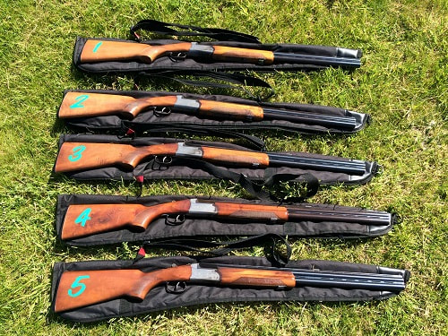 deactivated 12-bore shotguns resting on gun slips