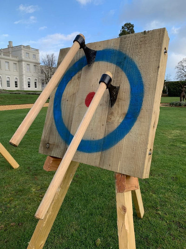 axes embedded in wooden target
